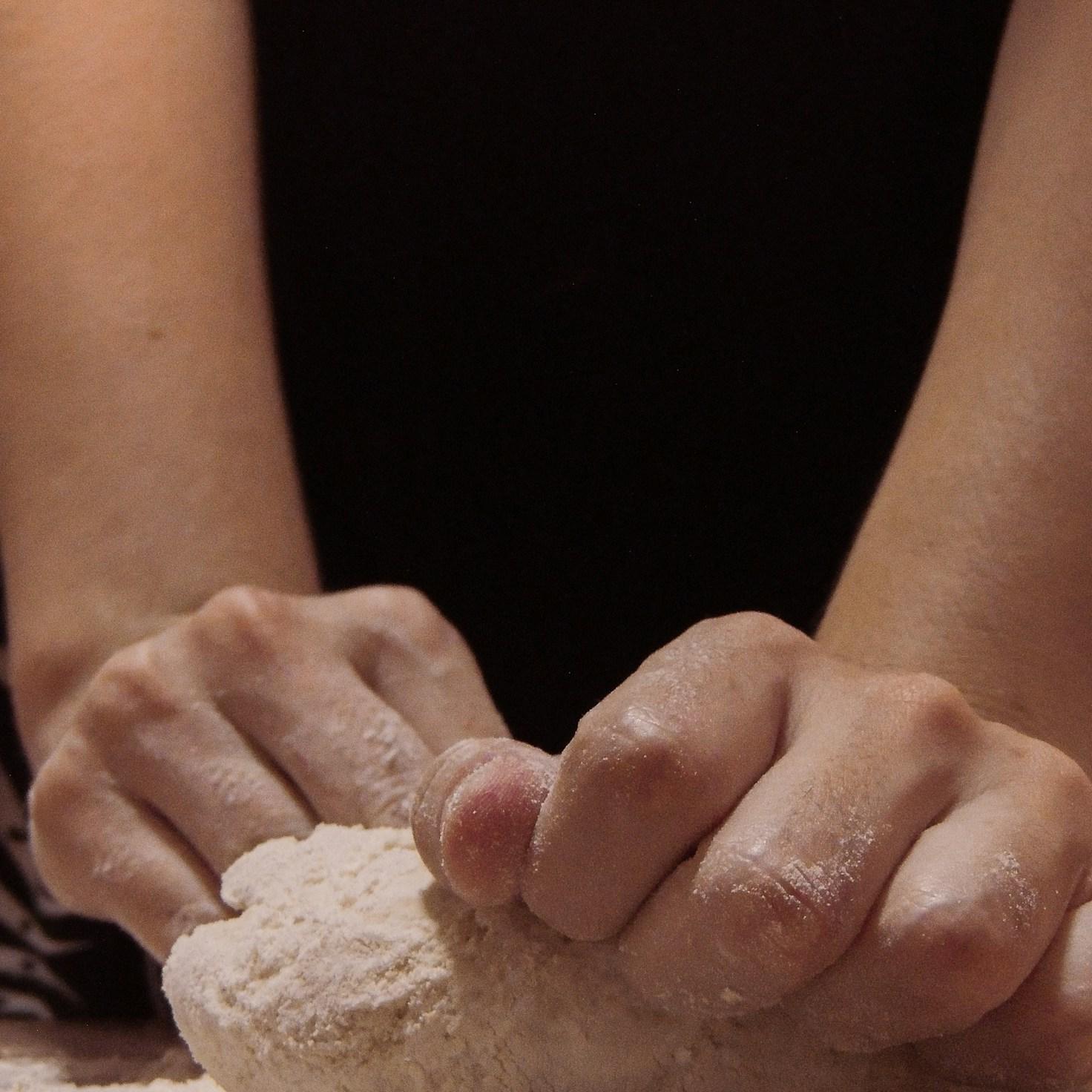Community members collaborating in a modern kitchen space, sharing recipes and techniques